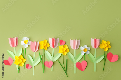 Happy Easter paper craft for kids. Paper DIY seasonal flowers tulips and hearts on pastel green background. Spring decor, create art for children, daycare, kindergarten, flyer greeting card