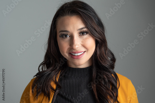 Studio headshot of beautiful young Latina business woman with room for copy. photo