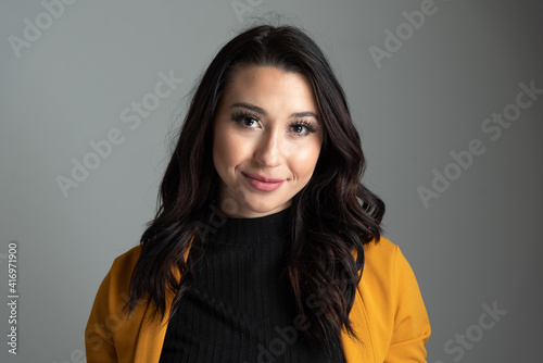 Studio headshot of beautiful young Latina business woman with room for copy.