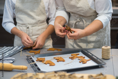 the process of making gingerbread. baking holiday cookies at home. cookies of different shapes on a baking sheet