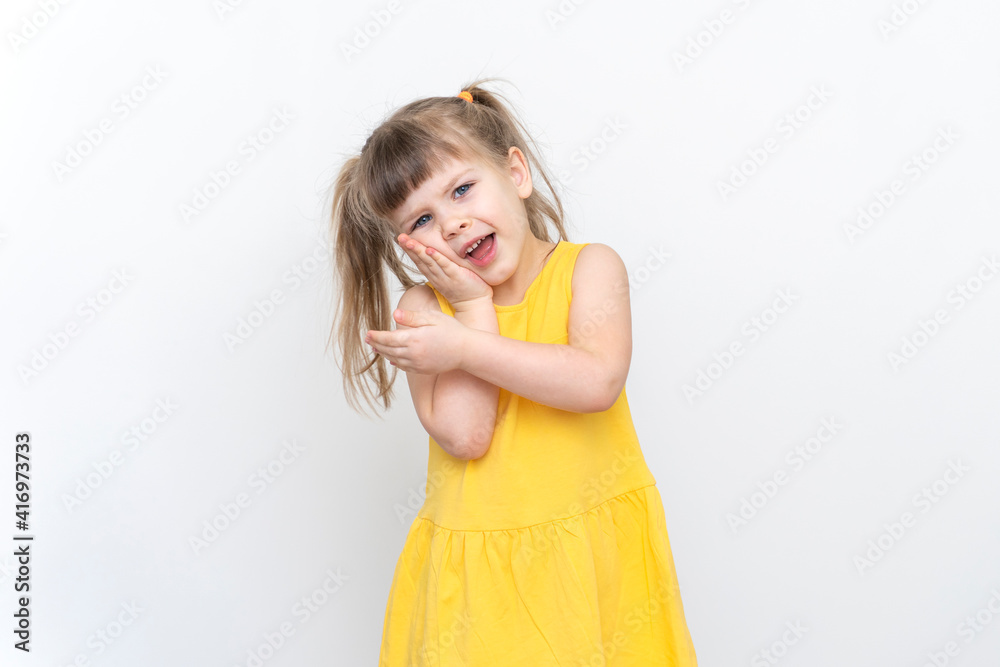 a little girl in a yellow dress has a toothache a little girl in a yellow dress has a toothache