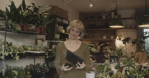 Wallpaper Mural Mature female small business owner working on digital tablet in store taking inventory Torontodigital.ca