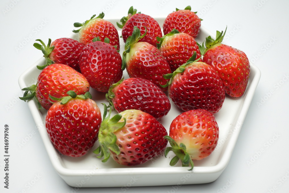 Heap of fresh strawberries in white ceramic dish Heap of fresh strawberries in white ceramic dish