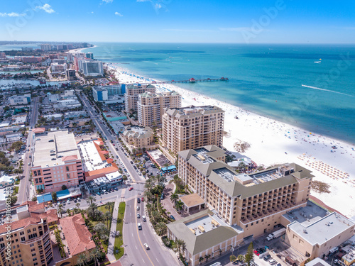 Spring break or Summer vacations in Florida. Ocean beach. Hotels, restaurants and Resorts in US. Blue-turquoise color water. American Coast or shore Gulf of Mexico. Clearwater Beach FL. Aerial view © artiom.photo