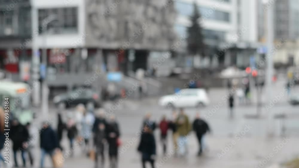 Defocused blur abstract background of many people waiting to cross the crosswalk in gray spring or autumn day Defocused blur abstract background of many people waiting to cross the crosswalk in gray spring or autumn day