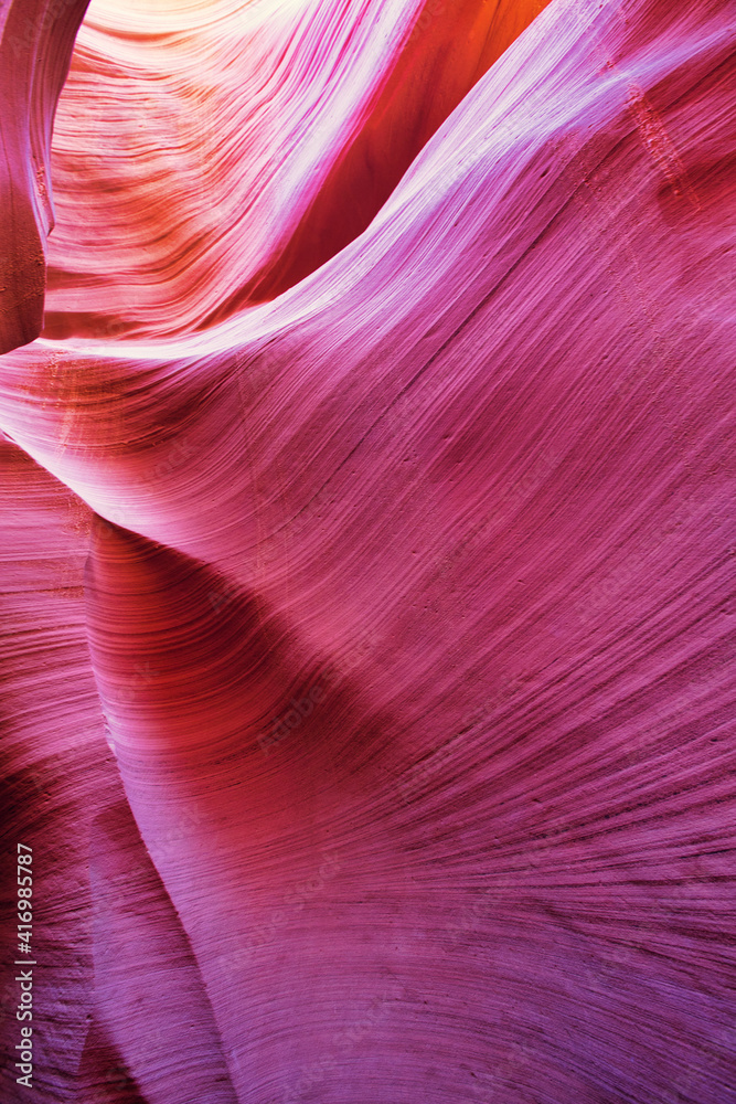 Obraz premium Beautiful red and orange sandstone wall with warm subtle light glow inside Antelope Canyon, Arizona, America