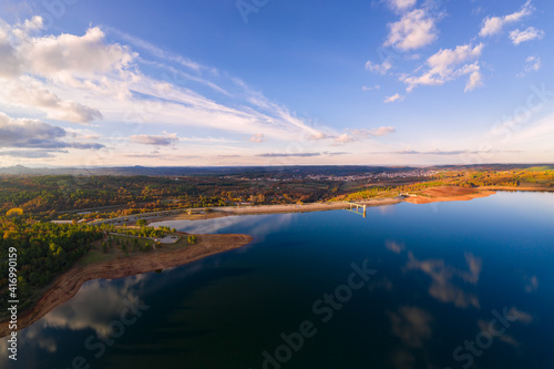 Drone aerial panoramic view of Sabugal Dam lake reservoir with perfect reflection, in Portugal