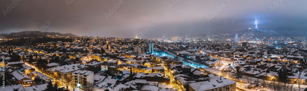 Snowy city night panorama