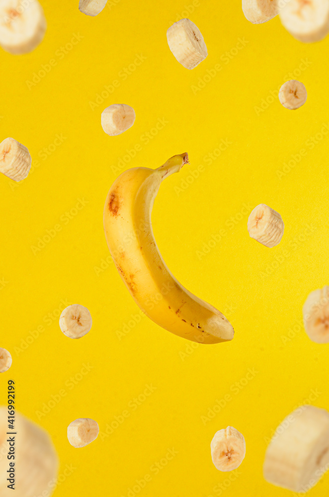 Banana floating yellow background