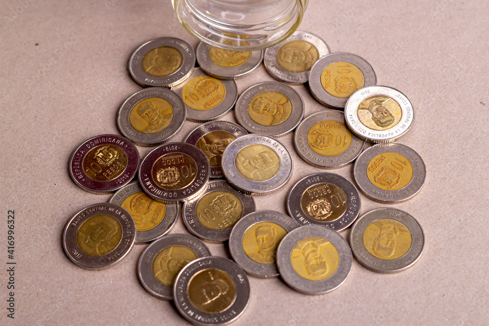 Top view dominican money in a glass jar Top view dominican money in a glass jar