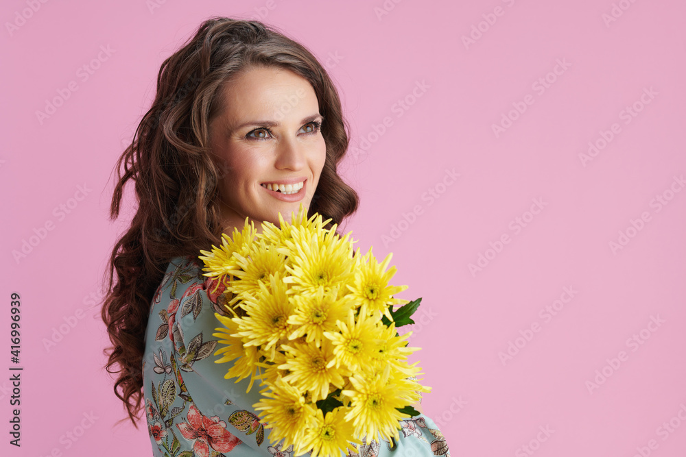 smiling 40 years old woman with long wavy brunette hair on pink smiling 40 years old woman with long wavy brunette hair on pink