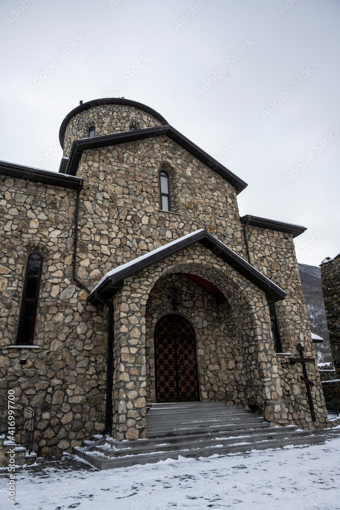 Fototapeta premium gray stone Christian church in the mountains in the Caucasus