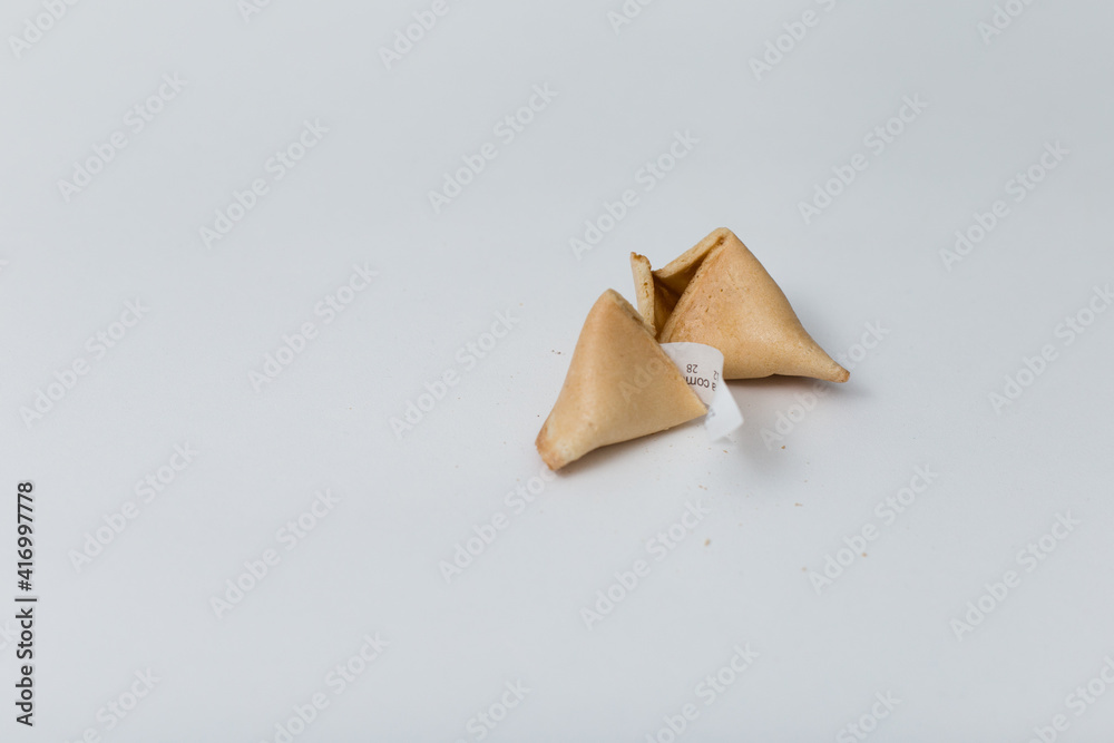 Broken fortune cookie on a white background