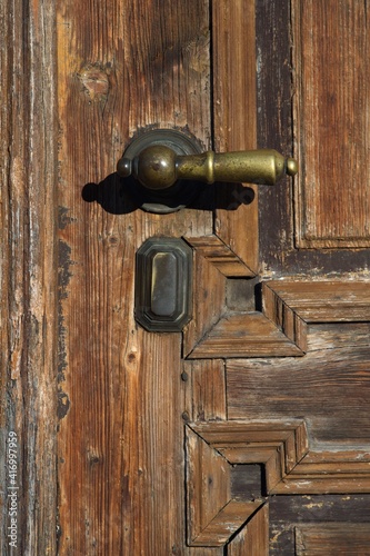 old wooden door from the house, brass door handle