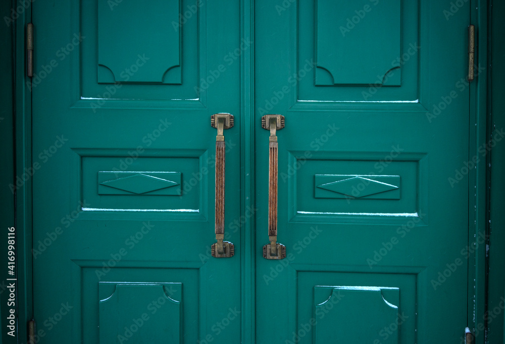 Fototapeta premium Antique brass knobs on the green doors of the Hermitage