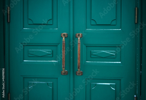 Antique brass knobs on the green doors of the Hermitage © Svetliy