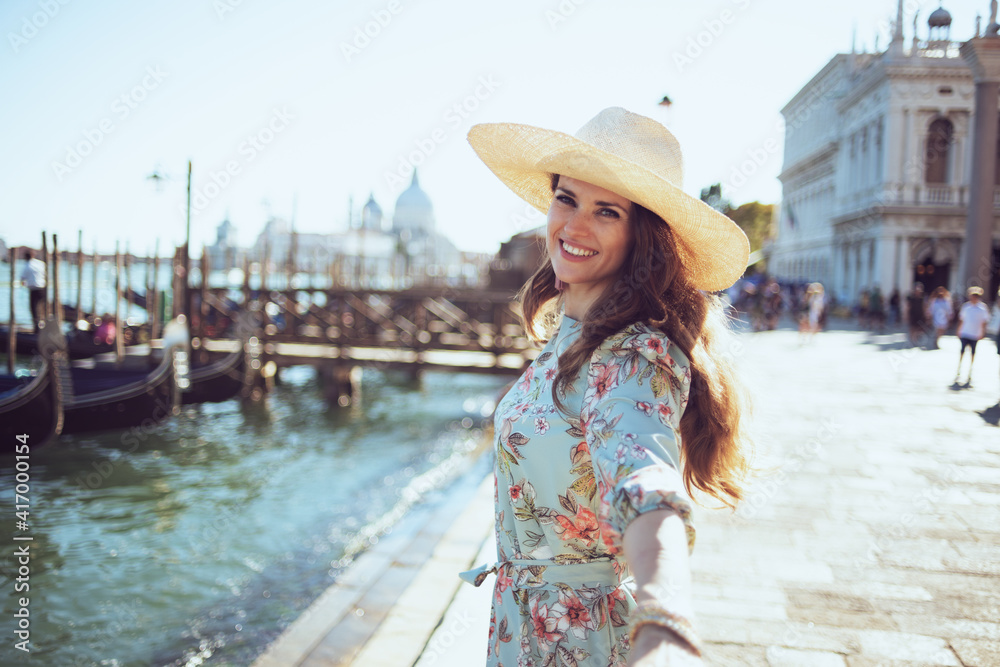 happy traveller woman in floral dress exploring attractions