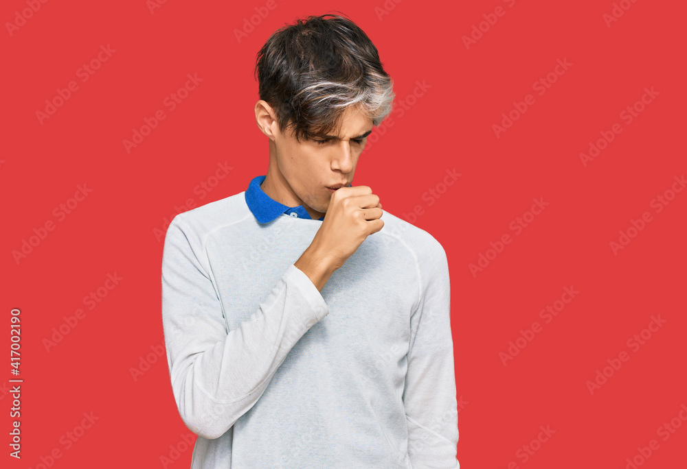 Young hispanic man wearing casual clothes feeling unwell and coughing as symptom for cold or bronchitis. health care concept. Young hispanic man wearing casual clothes feeling unwell and coughing as symptom for cold or bronchitis. health care concept.