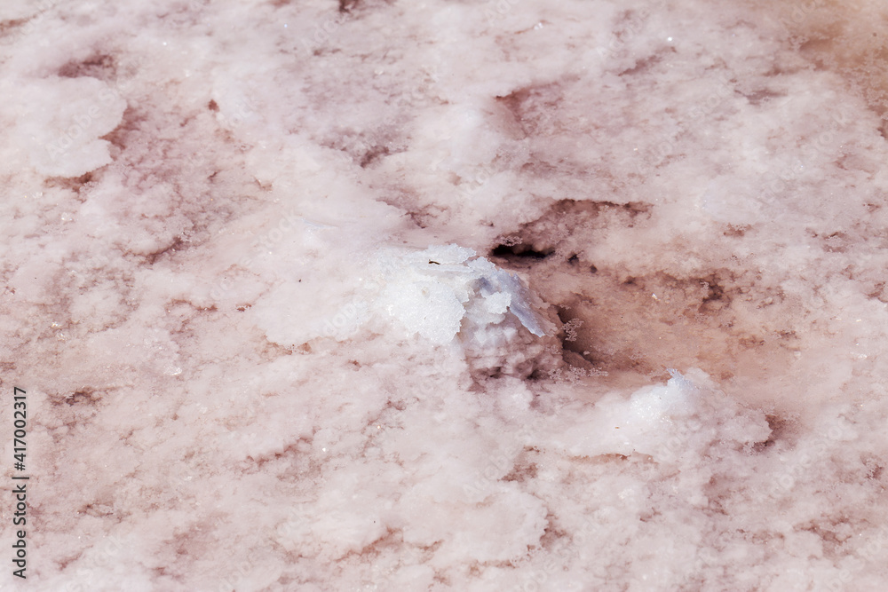 Fototapeta premium Pink salt in salt lake as textured background. Salt background.
