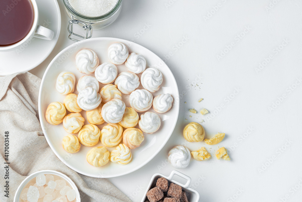 Swiss meringues in a plate on a light background. Swiss meringues in a plate on a light background.