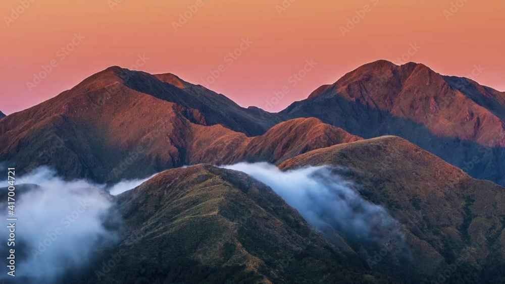 Beautiful evening sunset over misty alpine mountains in wild New Zealand landscape of Tararua Mountain Range Nature outdoor Time lapse