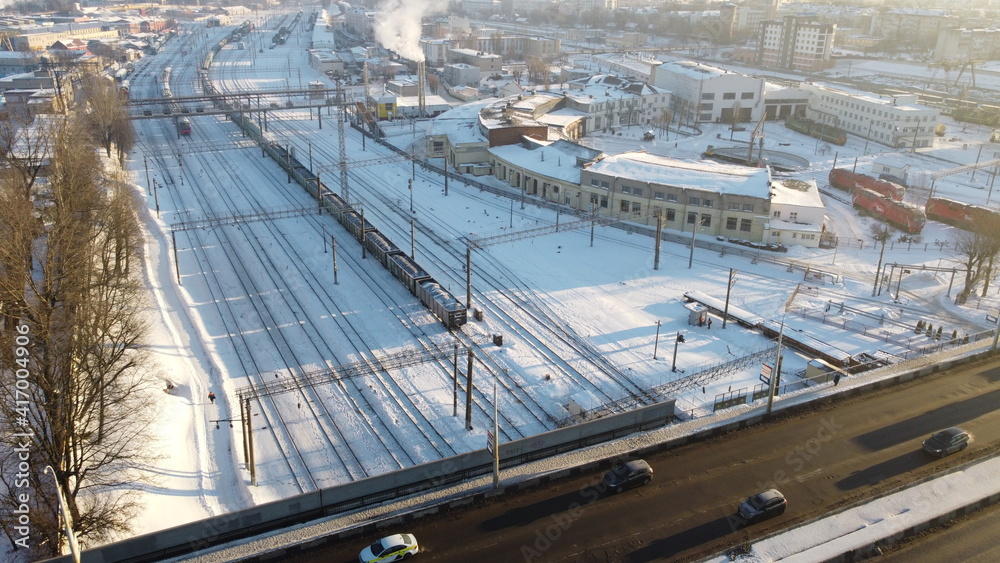 Top view on rails in snowy city