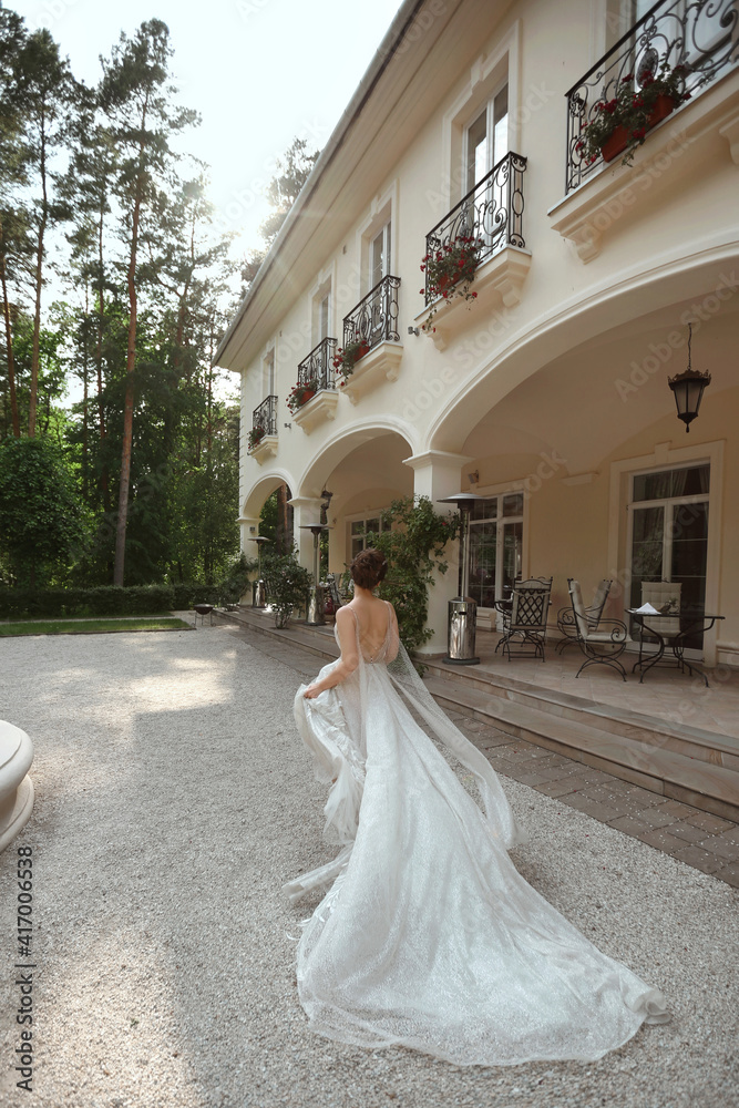 Young model woman in lace wedding dress escape from the wedding ceremony. Young runaway bride in fashionable wedding dress outdoors Young model woman in lace wedding dress escape from the wedding ceremony. Young runaway bride in fashionable wedding dress outdoors