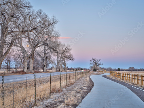 newly constructed bike trail segment in northern Colorado near Windsor, fall or winter scenery at dusk with a full moon