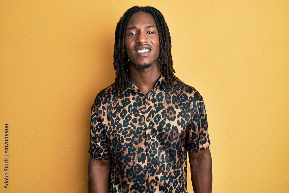 African american man with braids wearing leopard animal print shirt with a happy and cool smile on face. lucky person. African american man with braids wearing leopard animal print shirt with a happy and cool smile on face. lucky person.