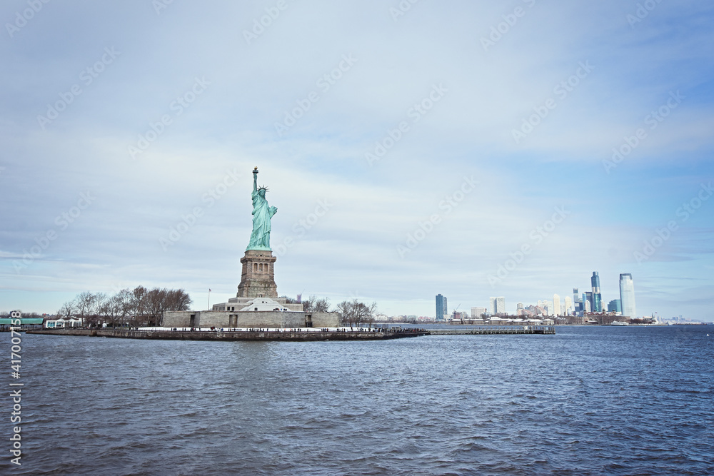 Statue of Liberty, colossal neoclassical sculpture and also known as Liberty Enlightening the World seen in a cruise on Hudson river.