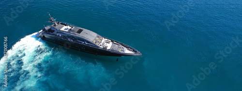 Aerial drone ultra wide photo of luxury yacht cruising in deep blue sea near Mediterranean Aegean Sea island