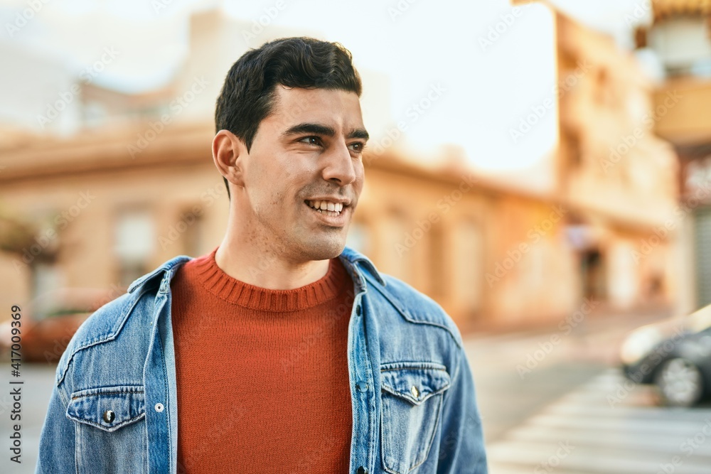 Young hispanic man smiling happy standing at the city. Young hispanic man smiling happy standing at the city.