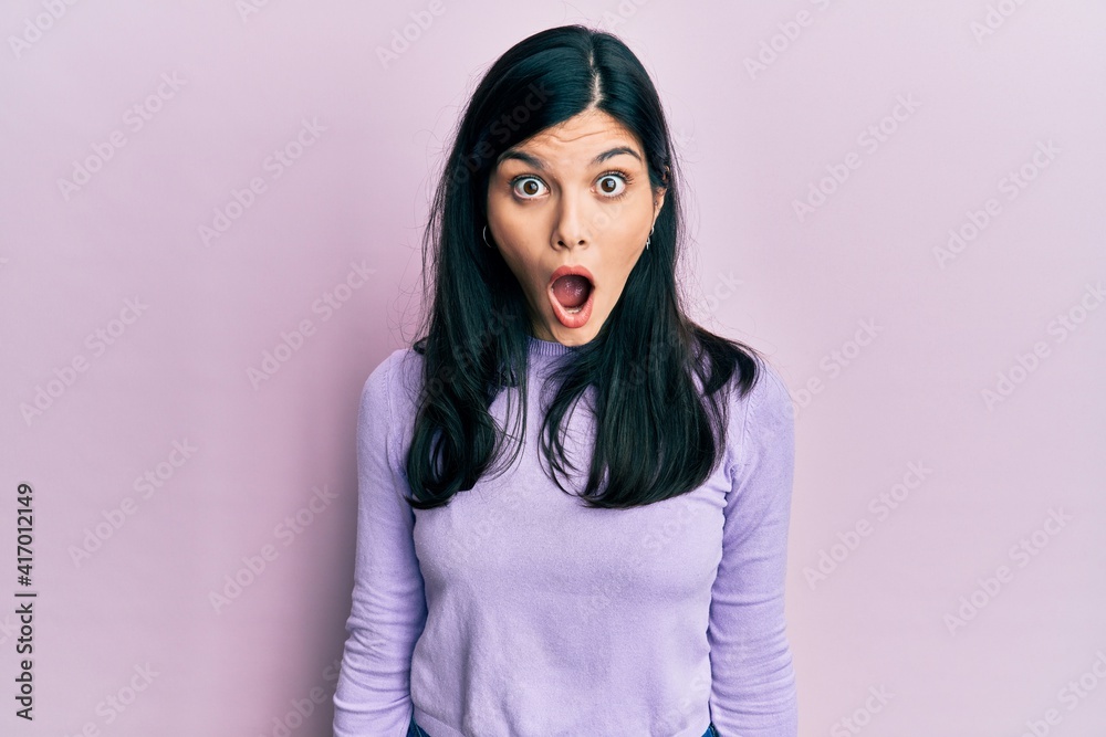 Young hispanic woman wearing casual clothes afraid and shocked with surprise and amazed expression, fear and excited face. Young hispanic woman wearing casual clothes afraid and shocked with surprise and amazed expression, fear and excited face.