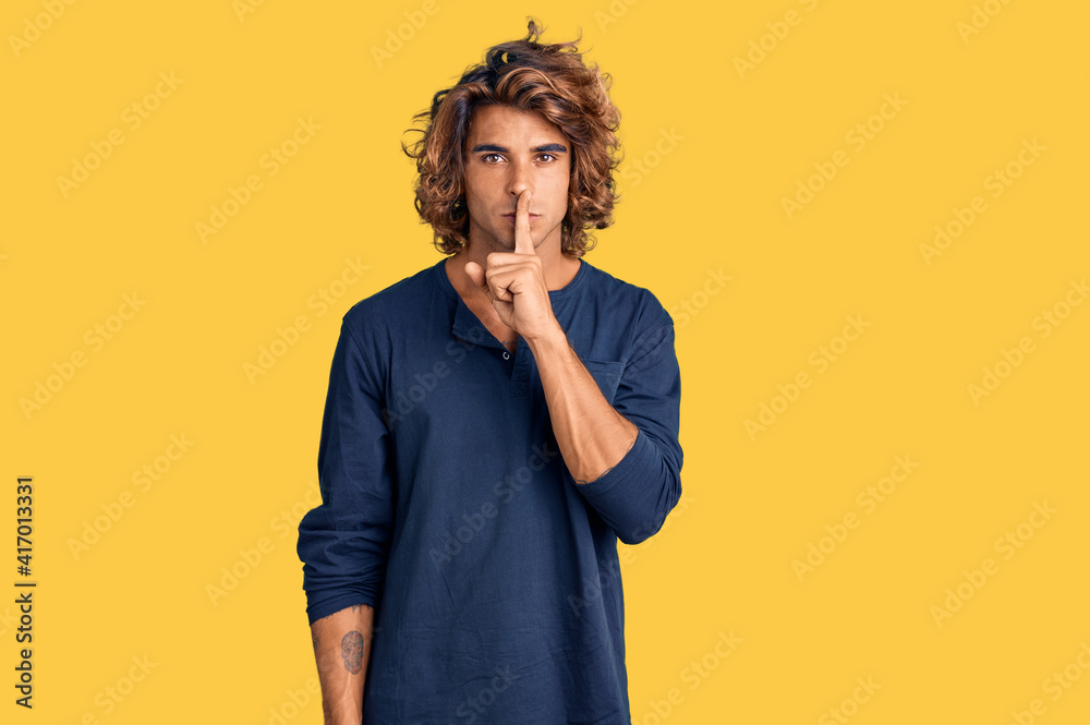 Young hispanic man wearing casual clothes asking to be quiet with finger on lips. silence and secret concept. Young hispanic man wearing casual clothes asking to be quiet with finger on lips. silence and secret concept.