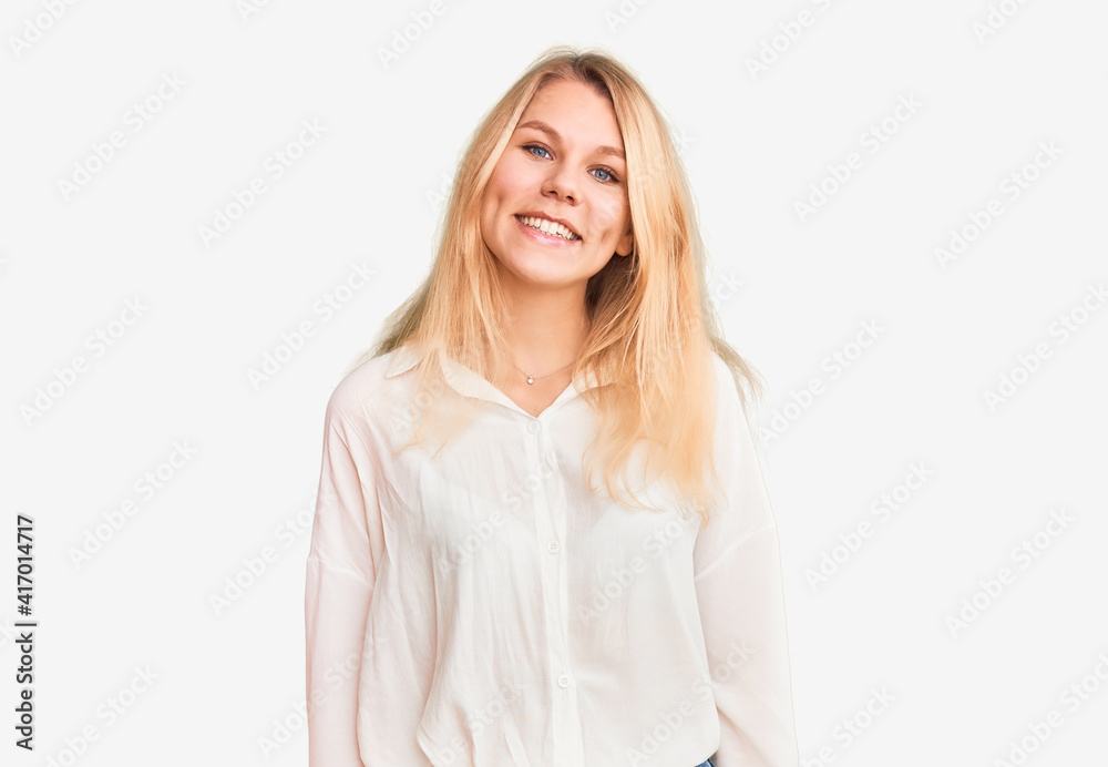 Young beautiful blonde woman wearing casual shirt looking positive and happy standing and smiling with a confident smile showing teeth Young beautiful blonde woman wearing casual shirt looking positive and happy standing and smiling with a confident smile showing teeth