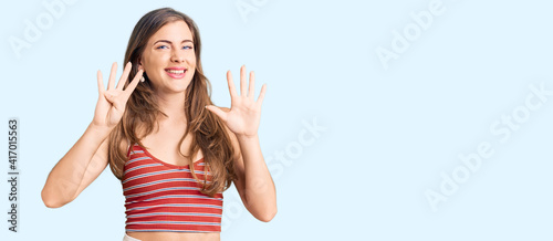 Beautiful caucasian young woman wearing casual clothes showing and pointing up with fingers number nine while smiling confident and happy.