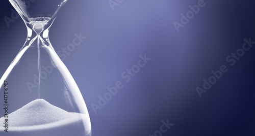 Sand running through the bulbs of an hourglass