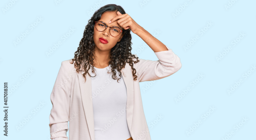 Young african american girl wearing business clothes pointing unhappy to pimple on forehead, ugly infection of blackhead. acne and skin problem Young african american girl wearing business clothes pointing unhappy to pimple on forehead, ugly infection of blackhead. acne and skin problem