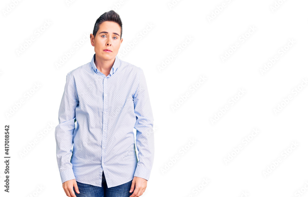 Young woman with short hair wearing business clothes relaxed with serious expression on face. simple and natural looking at the camera. Young woman with short hair wearing business clothes relaxed with serious expression on face. simple and natural looking at the camera.