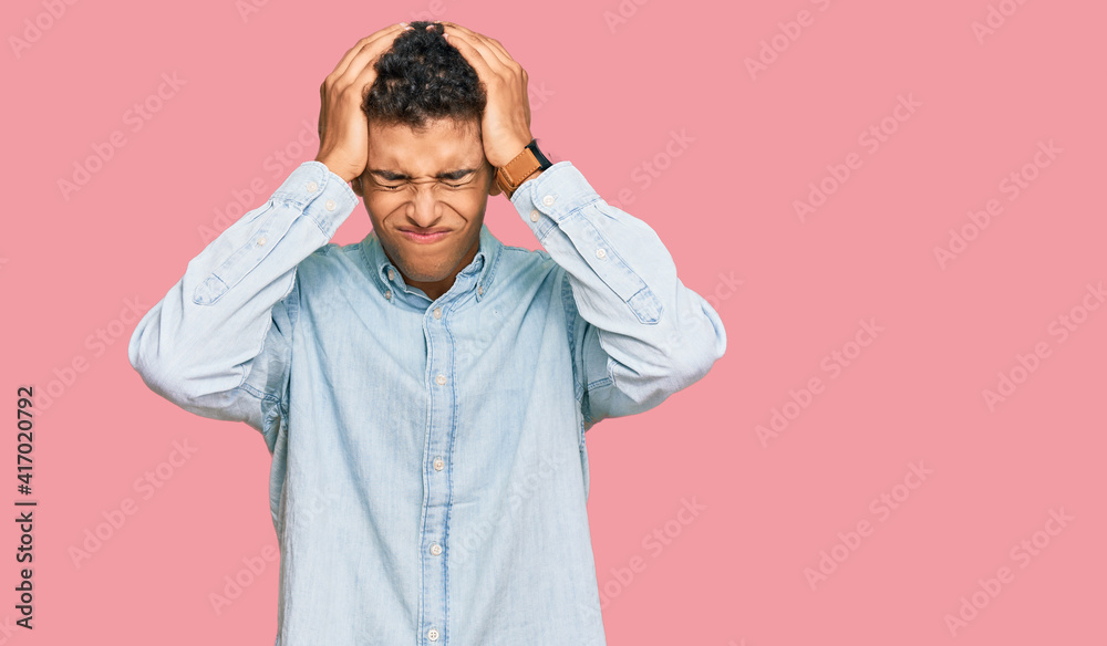 Young handsome african american man wearing casual clothes suffering from headache desperate and stressed because pain and migraine. hands on head.