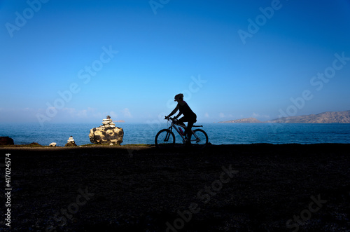 Person riding bicycle near the coast