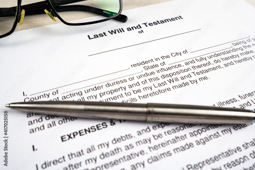 Last will and testament document with pen and glasses on top. Last will and testament document with pen and glasses on top.