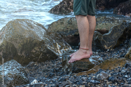 Man legs on rock beach coast
