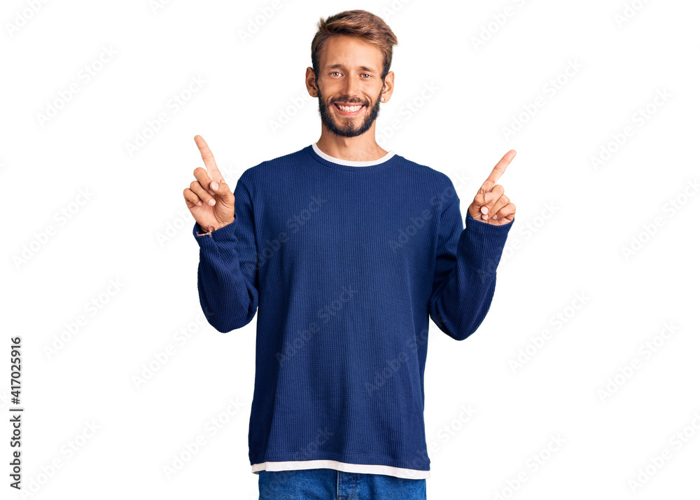 Handsome blond man with beard wearing casual sweater smiling confident pointing with fingers to different directions. copy space for advertisement Handsome blond man with beard wearing casual sweater smiling confident pointing with fingers to different directions. copy space for advertisement