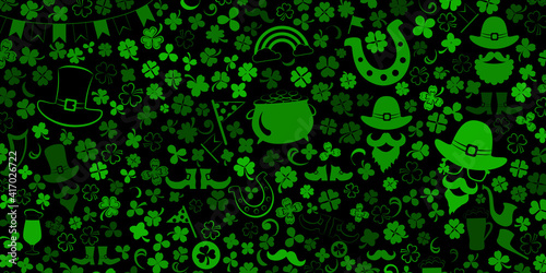 Background on St. Patrick s Day made of clover leaves and other symbols in green colors