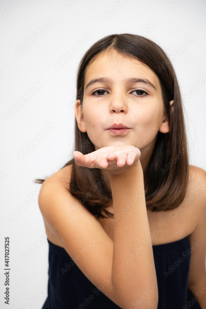 Girl, schoolgirl expresses emotions, indicates the direction close-up on a white background Girl, schoolgirl expresses emotions, indicates the direction close-up on a white background