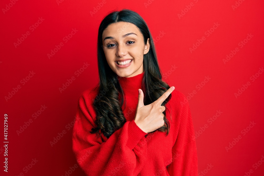 Young hispanic woman wearing casual clothes smiling cheerful pointing with hand and finger up to the side Young hispanic woman wearing casual clothes smiling cheerful pointing with hand and finger up to the side