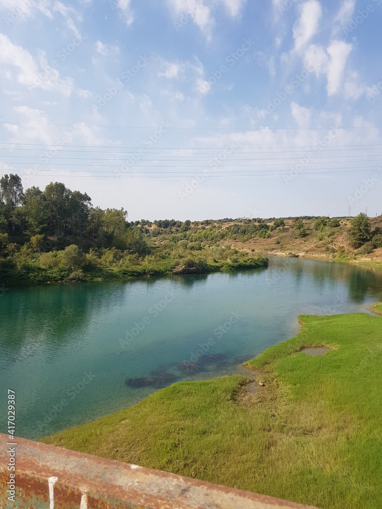 The river flowing through the green fields