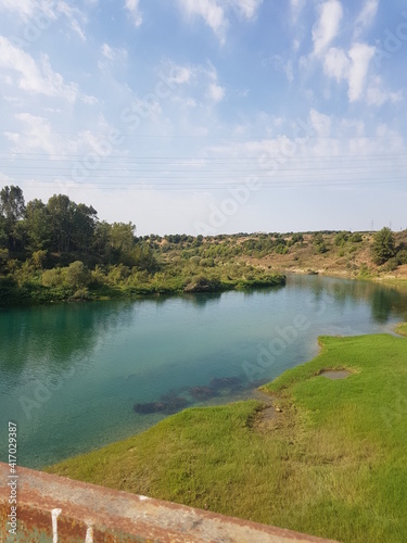 The river flowing through the green fields