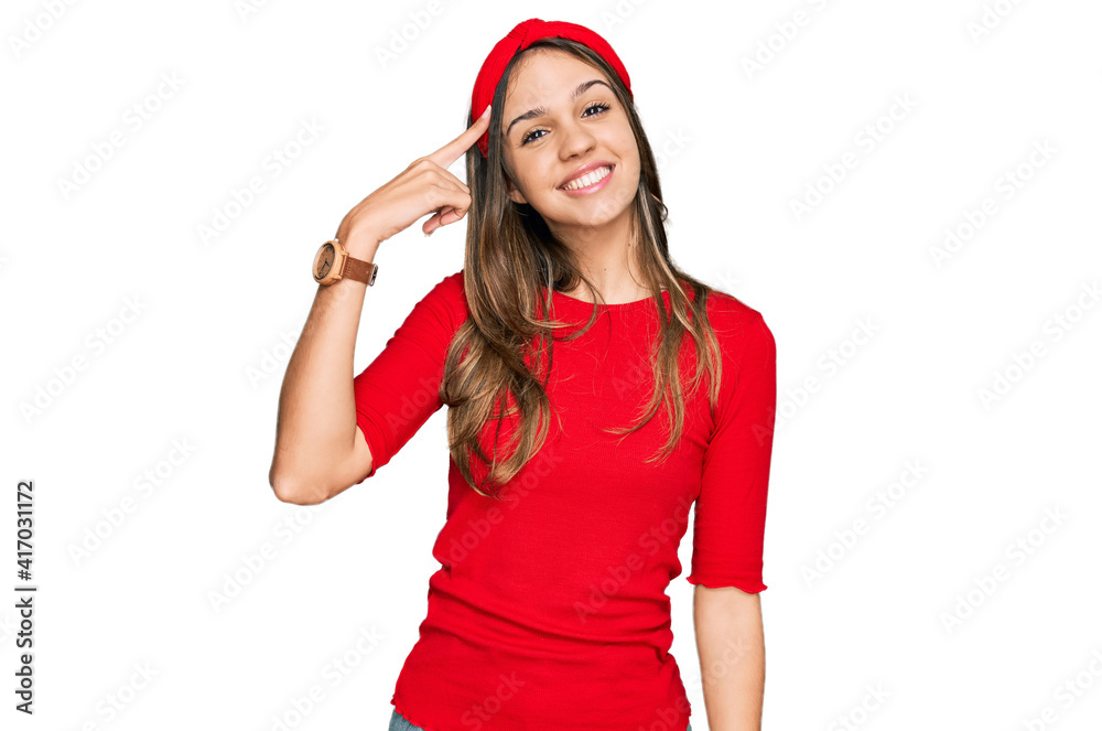 Young brunette woman wearing casual clothes smiling pointing to head with one finger, great idea or thought, good memory Young brunette woman wearing casual clothes smiling pointing to head with one finger, great idea or thought, good memory
